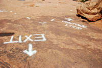 Trail markings are painted on the rock.